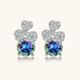 Sterling silver stud earrings with four-leaf clover design featuring small crystals above round moissanite stones