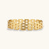 Wide 18K gold plated stainless steel bracelet with a multi-row rectangular grid link chain pattern on a cream background.