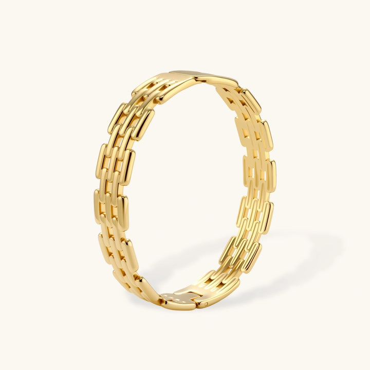 Wide 18K gold plated stainless steel bracelet with a multi-row rectangular grid link chain pattern on a cream background.