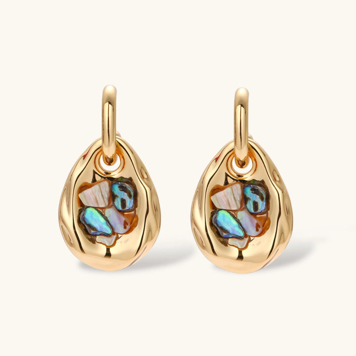 Gold-plated convertible hoop earrings with iridescent shell mosaic pendants, shown assembled and separated on cream background.