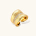 Adjustable gold-plated cuff ring with parallel ridged texture and diagonal row of sparkling zirconia stones on white background.